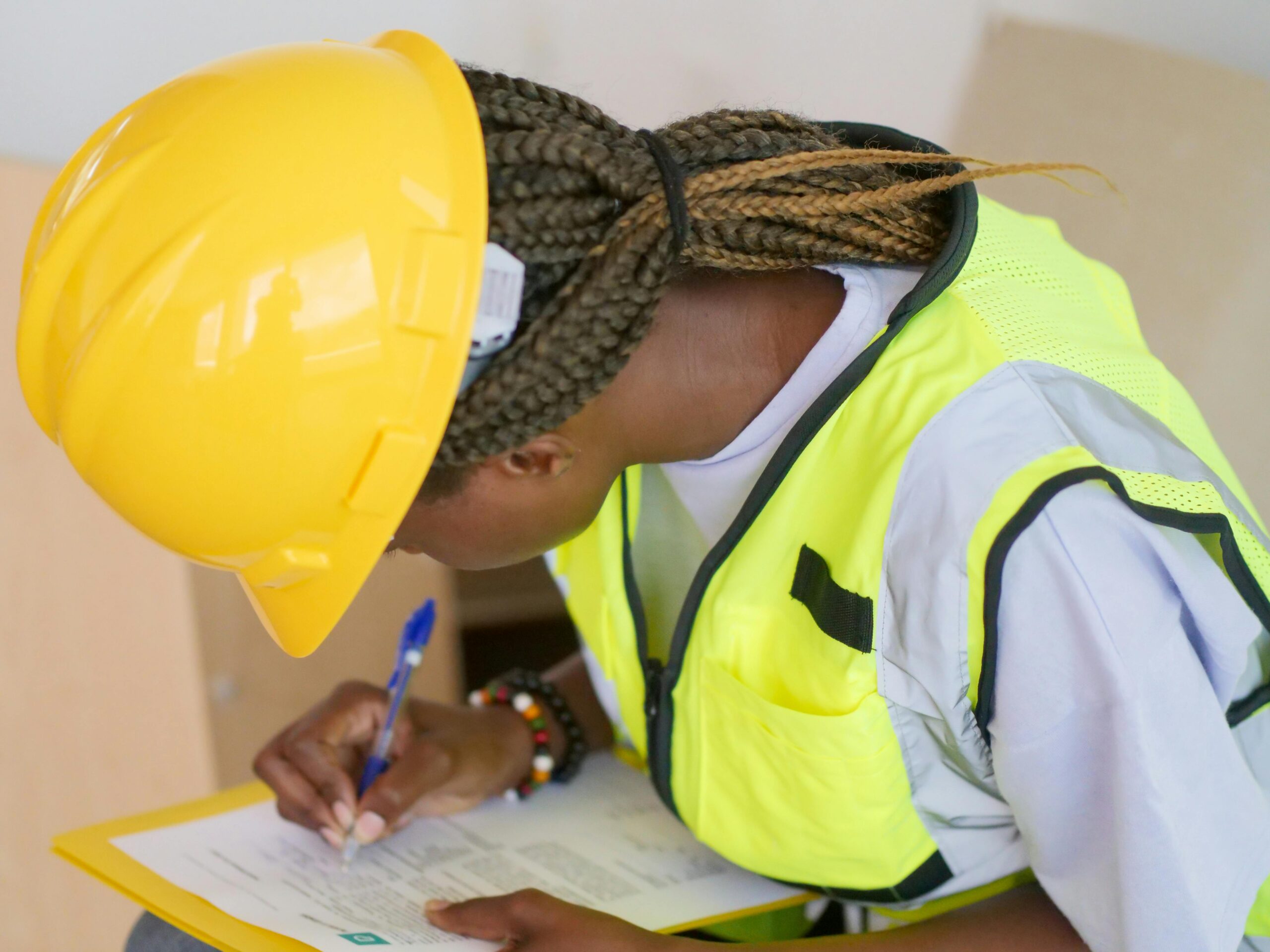 Woman engineer writing down on paper